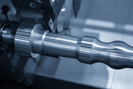 CNC lathe turning a stepped shaft